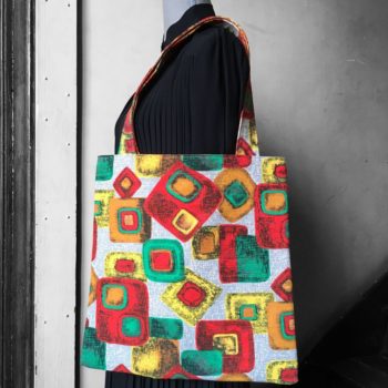 Grand totebag en tissu vintage, imprimé géométrique graphique abstrait, époque moderne atomique milieu du XXe siècle, en vert jaune orange et rouge sur fond gris.